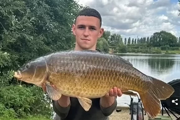 Relaxed end to break! Foden catches a whopper on a £14-a-day fishing pond and poses for a snap